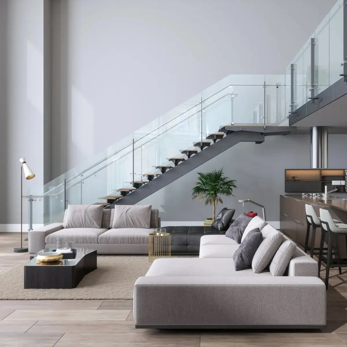 Interno di una casa. L'ambiente è un soggiorno ed è presente una scala in acciaio e vetro.